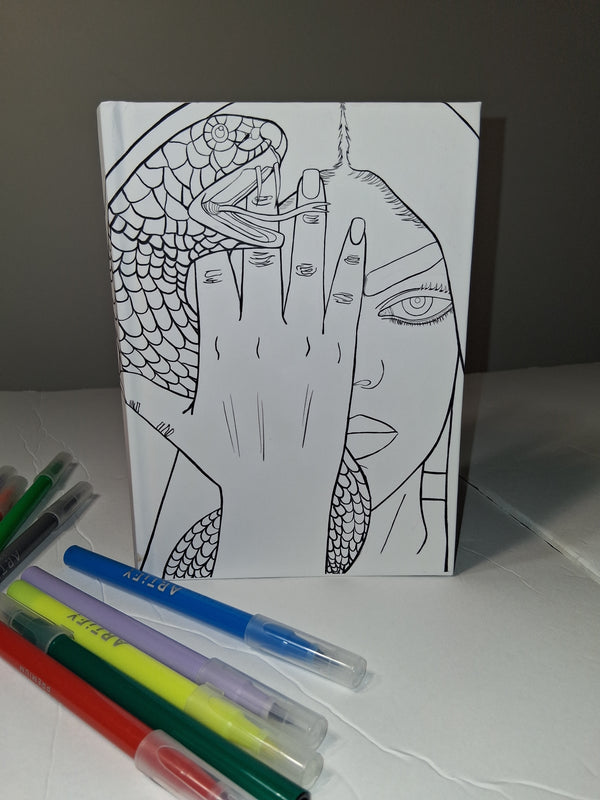 Coloring book with a hand-drawn design and markers on a table